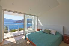 Room with coastal-oriented windows maximizing natural light entry